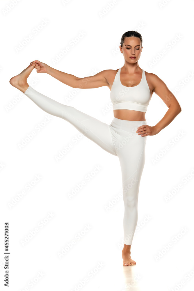 Portrait of young beautiful woman in white sportswear doing yoga practic Portrait of young beautiful woman in white sportswear doing yoga practic