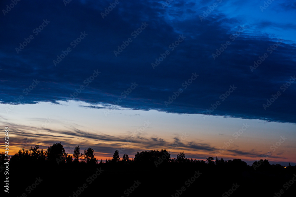 Sunset with the silhouette of the forest