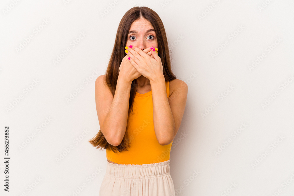 Young caucasian woman isolated on white background shocked covering mouth with hands. Young caucasian woman isolated on white background shocked covering mouth with hands.
