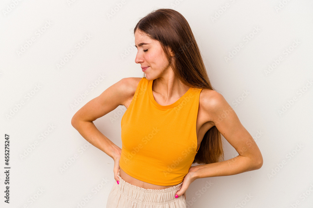 Young caucasian woman isolated on white background suffering a back pain. Young caucasian woman isolated on white background suffering a back pain.