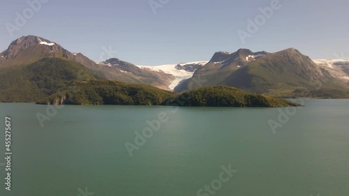 Drone flight over fjord towards glacier in mountainous valley photo