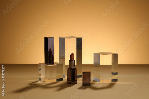 
Blank Lipstick mock-ups on glass podiums and geometrical forms. Abstract Background for branding and packaging presentation. 