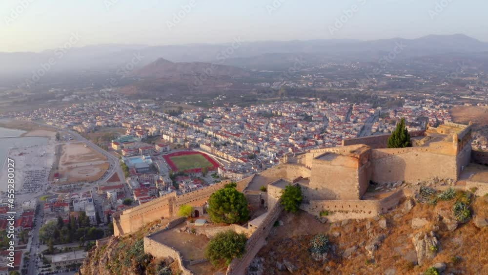 Aerial summer cityscape of Nafplion town. 4k drone forward video (Ultra High Definition) of Fortress of Palamidi. Amazing sunset on Peloponnese peninsula, Greece, Europe. . Aerial summer cityscape of Nafplion town. 4k drone forward video (Ultra High Definition) of Fortress of Palamidi. Amazing sunset on Peloponnese peninsula, Greece, Europe. .