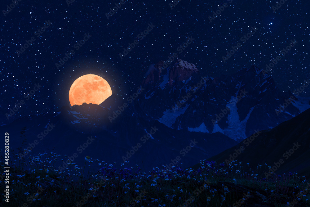 Moon and stars over mountains