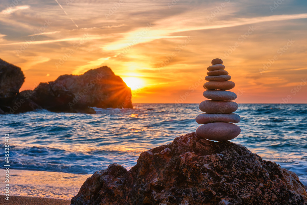 Concept of balance and harmony - stone stack on the beach - obrazy, fototapety, plakaty 