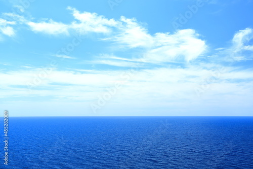 Horizon on the sea, bright sky with some clouds