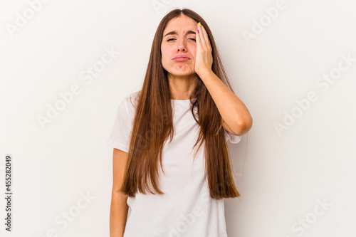 Young caucasian woman isolated on white background tired and very sleepy keeping hand on head.