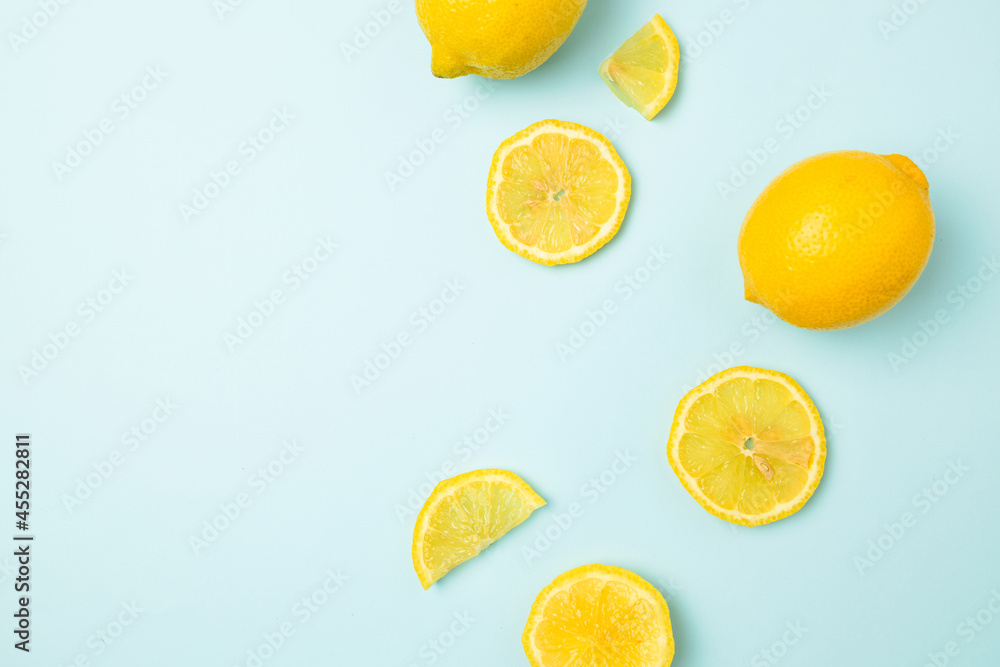 Ripe yellow lemons on blue background with copy space for your text. Top view. Flat lay pattern, banner. Frame made of fresh lemons Ripe yellow lemons on blue background with copy space for your text. Top view. Flat lay pattern, banner. Frame made of fresh lemons