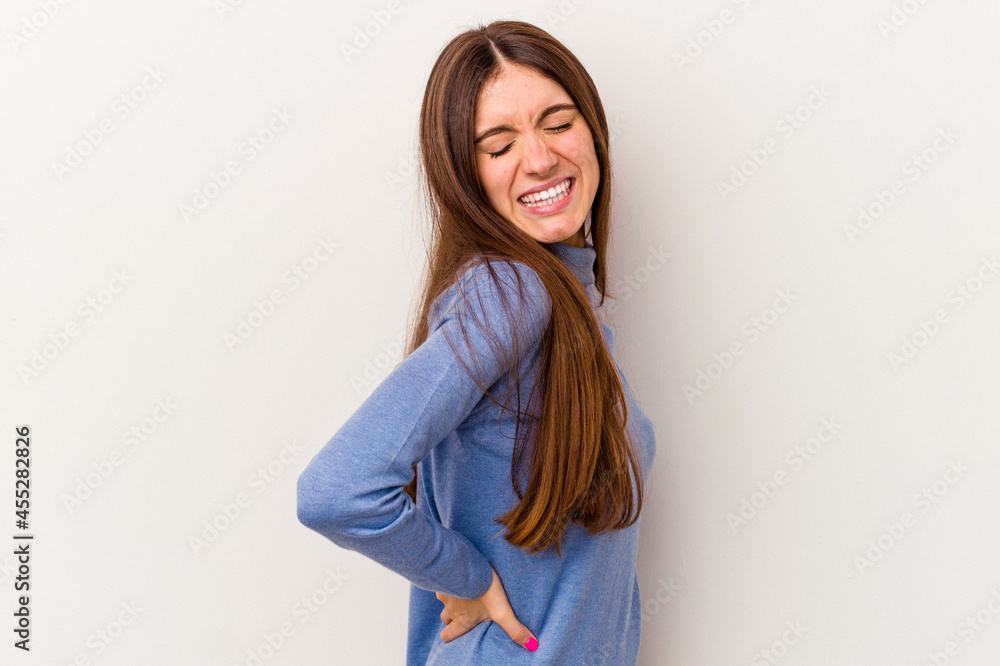 Young caucasian woman isolated on white background suffering a back pain. Young caucasian woman isolated on white background suffering a back pain.