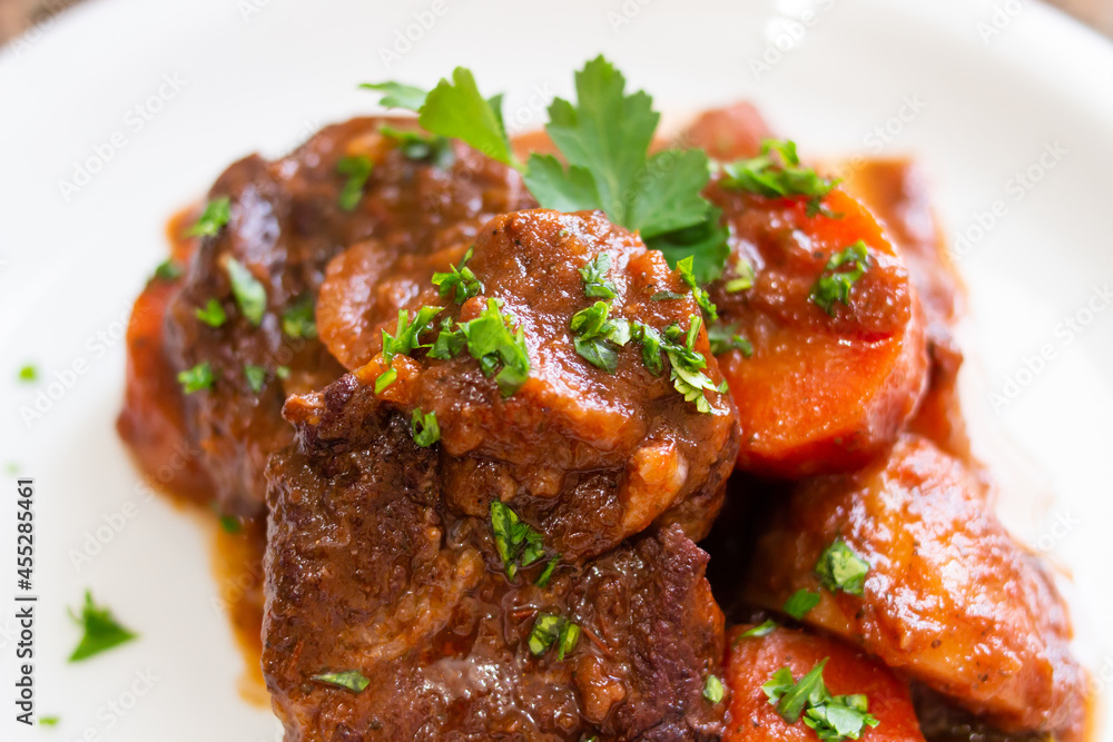 Close-up of pork stew with carrots and parsley Close-up of pork stew with carrots and parsley