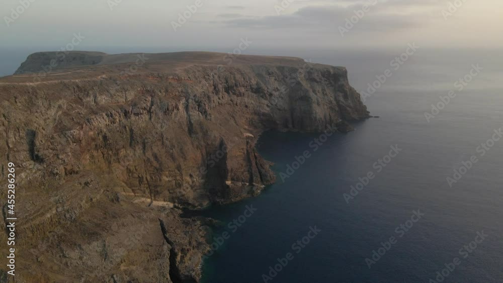 Drone flies towards the cliffs of Calheta slowly rising over the ocean. Drone flies towards the cliffs of Calheta slowly rising over the ocean.