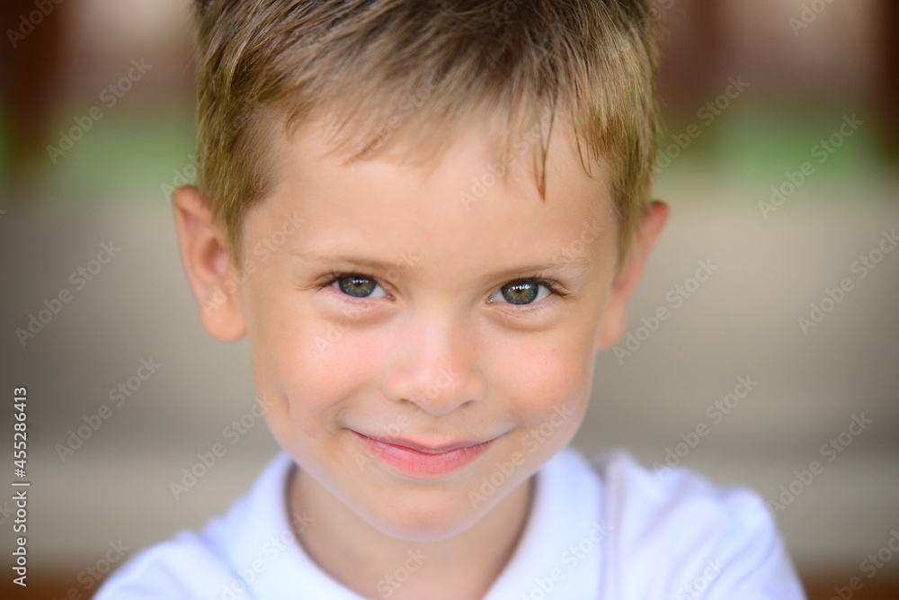 Portrait of young smiling boy in outdoors. Image with shallow DOF. Portrait of young smiling boy in outdoors. Image with shallow DOF.