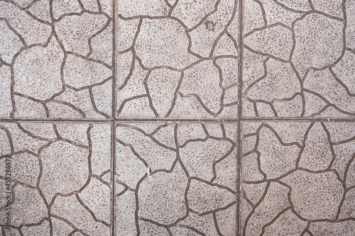 Texture of gray tiles with cracks