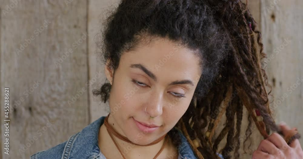 Portrait mixed race woman with dredlocks smiling Portrait mixed race woman with dredlocks smiling
