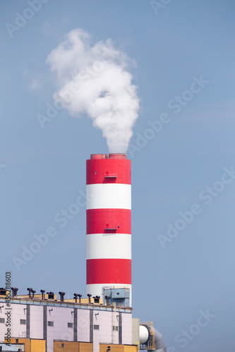 A close-up of the smoking stacks of a coal-fired power plant. Photo taken on a sunny day with good lighting conditions.