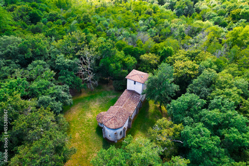 Aerial view of the old pilgrimage church of Lugo buitl in the middle of the forest. Gironde, France photo