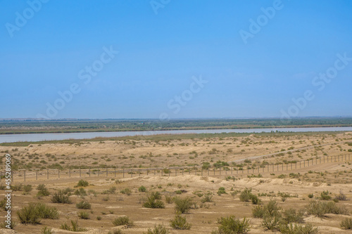 Panorama of Uzbek-Afghan border. In foreground is territory of Uzbekistan, beyond Amu Darya River lies Afghanistan