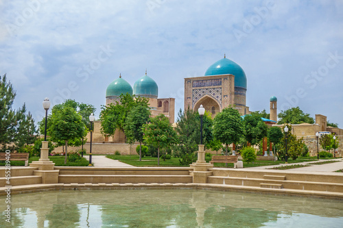 Panorama of Dorut Tilavat complex (founded in XIV), Shakhrisabz, Uzbekistan. Public park in foreground. From buildings of complex you can see domes of Kulal mausoleum and portal of Kok Gumbaz madrasah photo