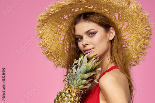 pretty woman in hat Pineapple in hands Exotic luxury close-up