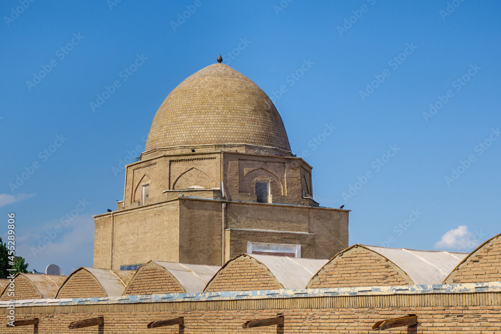 View of the Rukhabad mausoleum over the roofs of the cells of the madrasah of the same name. Shot in Samarkand, Uzbekistan