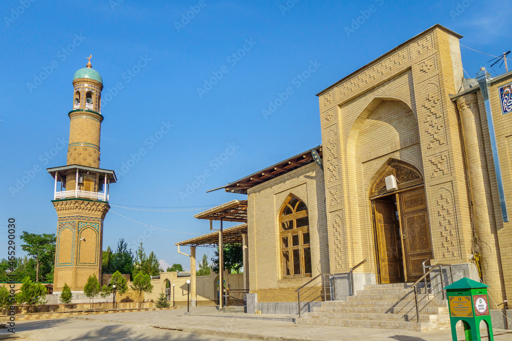 Entrance to Khoja Abdi Darun memorial complex, Samarkand, Uzbekistan. Mausoleum itself was founded in XII. Photo shows minaret of mosque and khanqah. Inscription on right translates as 'Donation box'
