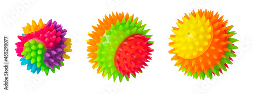 Massage rainbow multi colored prickly three balls isolated on white. Colorful bright isolated spiky toy ball  close up.  Rubber ball for games with dog or cat. Massage ball similar to coronavirus.