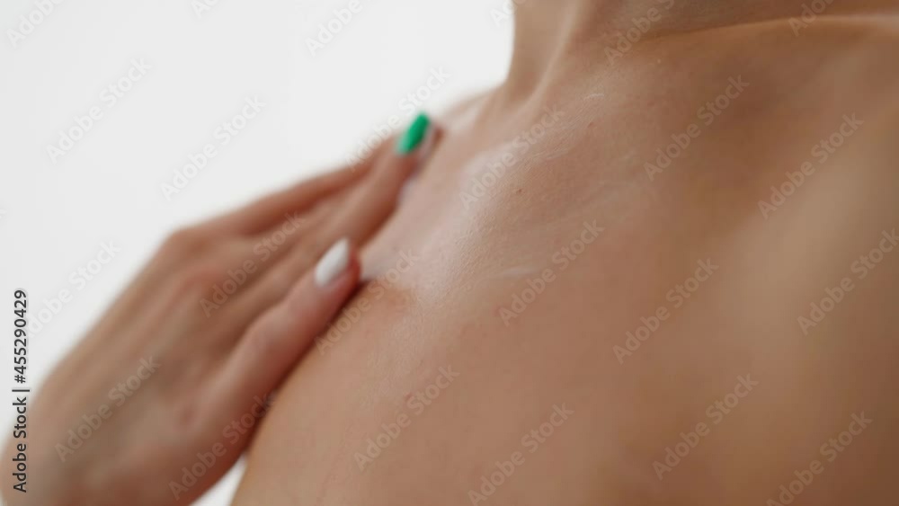 Close-up of a Young Woman Applying Moisturizer to Smooth Skin on a White Background. Skincare, Health and Beauty concept. Care cosmetics. Close-up of a Young Woman Applying Moisturizer to Smooth Skin on a White Background. Skincare, Health and Beauty concept. Care cosmetics.