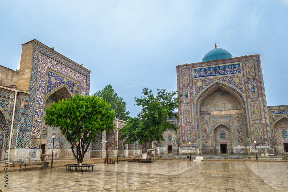 Western and southern iwans of Nadir Divan-Begi madrasah in Samarkand, Uzbekistan. Building is richly decorated with traditional ornaments and patterns. Built in 15th century