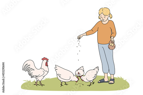 Farming, agriculture, feeding animals concept. Smiling girl cartoon character standing and feeding chicken hens with seeds from hand on grass vector illustration 