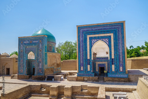 Medieval mausoleums of the 14th century in historical complex Shah-i Zinda, Samarkand, Uzbekistan. Some elements of building contain lines from Koran in Arabic photo