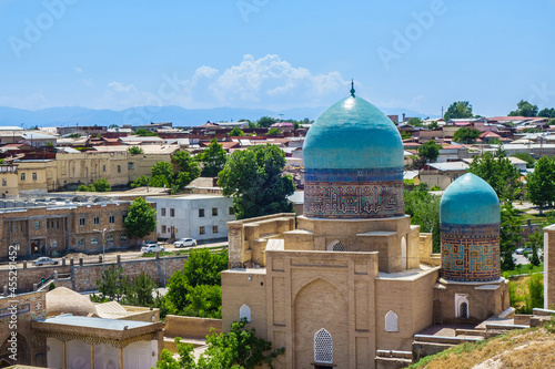 Two-domed mausoleum of medieval complex Shah-i Zinda against background of modern Samarkand, Uzbekistan photo