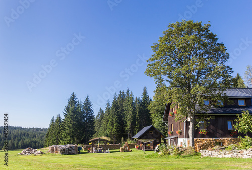 Traditional wooden house in the landscape of the Sumava mountains national park, Czech Republic