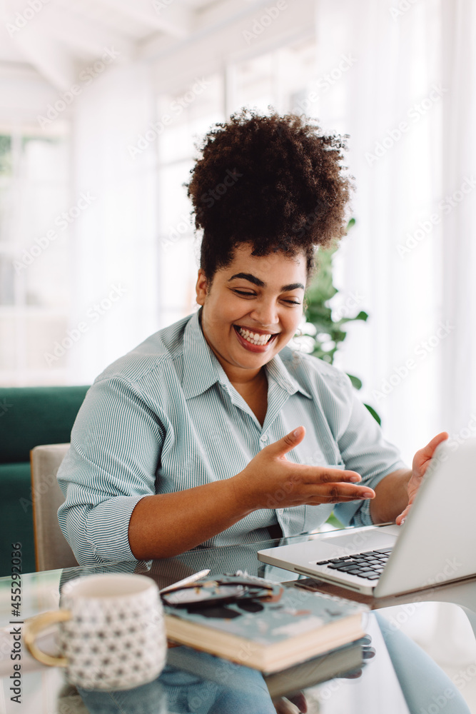 Woman working remotely video calling with laptop Woman working remotely video calling with laptop
