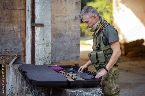 A man preparing for the airsoft game in military uniform