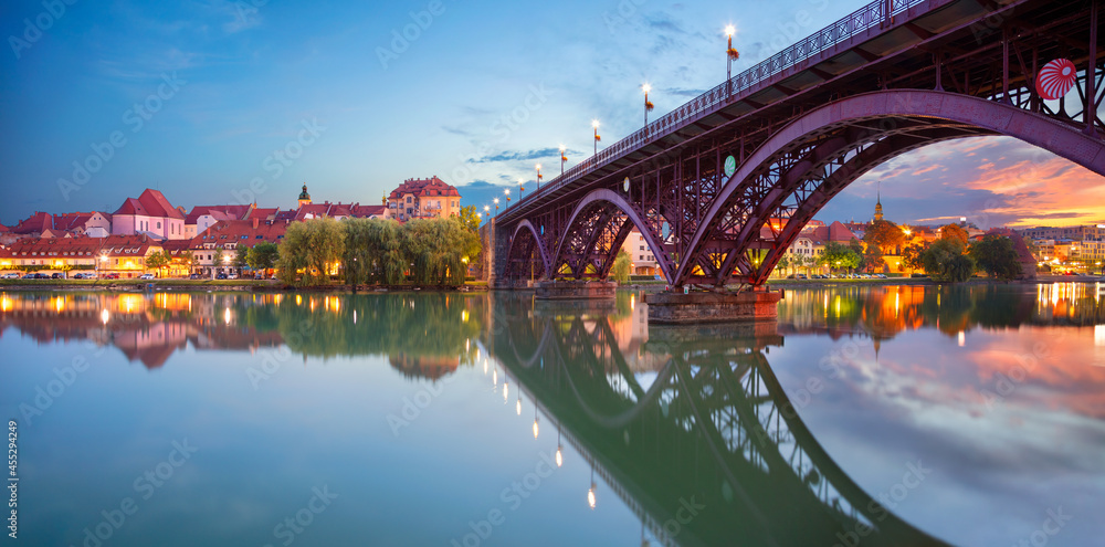 Maribor, Slovenia. Cityscape image of Maribor, Slovenia at beautiful summer sunrise with reflection of the city in Drava River.