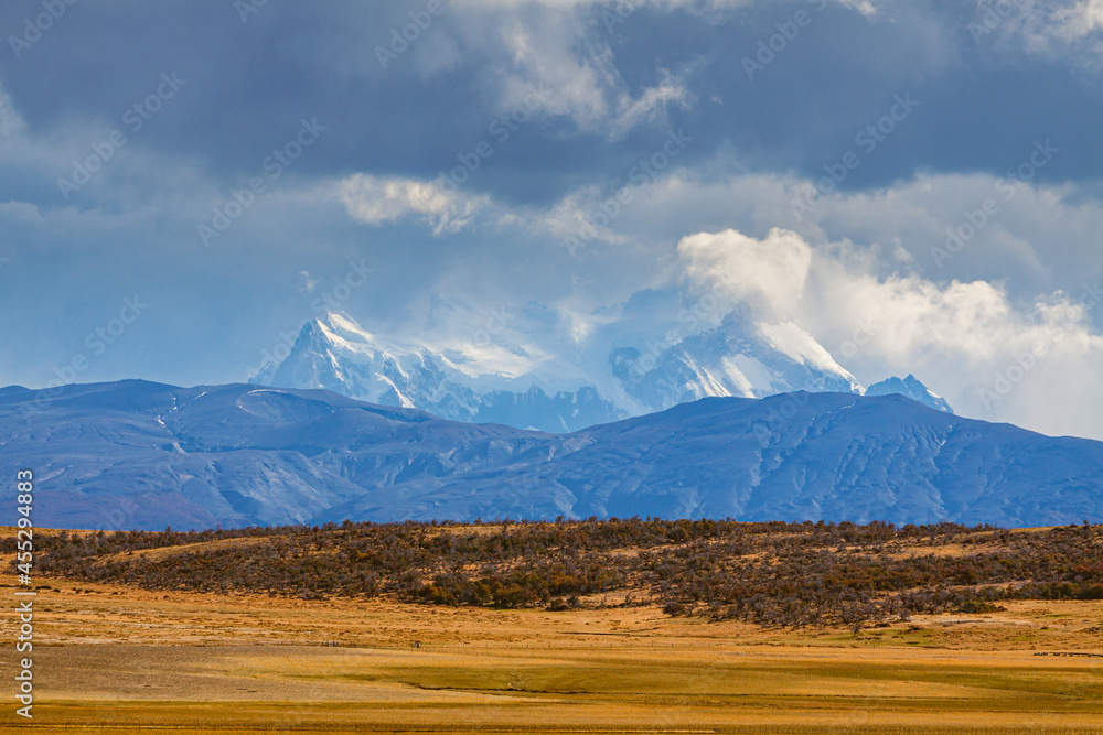 Landscape in Patagonia: the foothills of the Andes with the snow and glacier covered Paine mountain range in the background