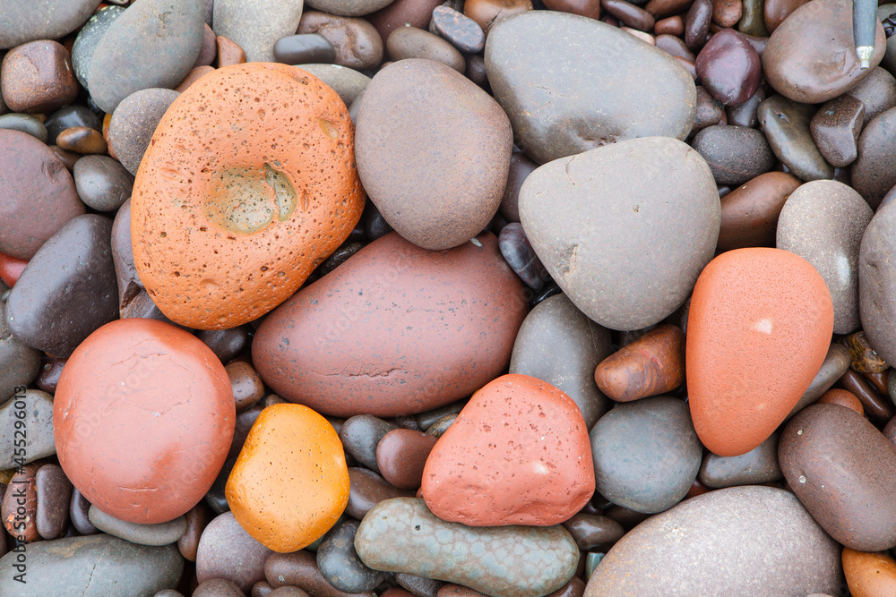 Colorful round cut stones on a pebble beach at the coast of Namibia