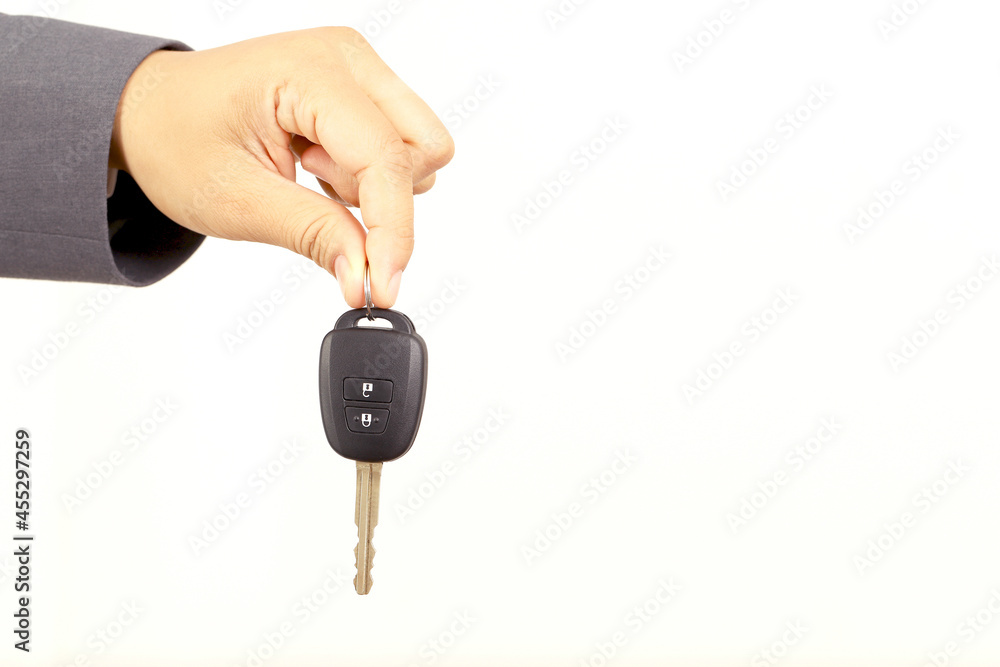 Salesman is carrying the car keys delivered to the customer at the showroom with a low interest offer. Special promotion Salesman is carrying the car keys delivered to the customer at the showroom with a low interest offer. Special promotion