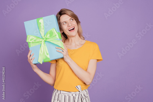 Photo of young attractive woman happy positive smile get present gift box birthday isolated over purple color background