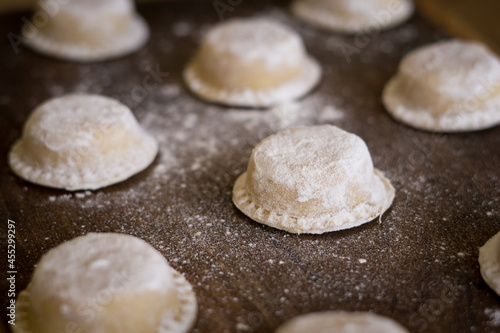 Closeup of fresh Argentinian pasta, sorrentinos on a chopping board photo