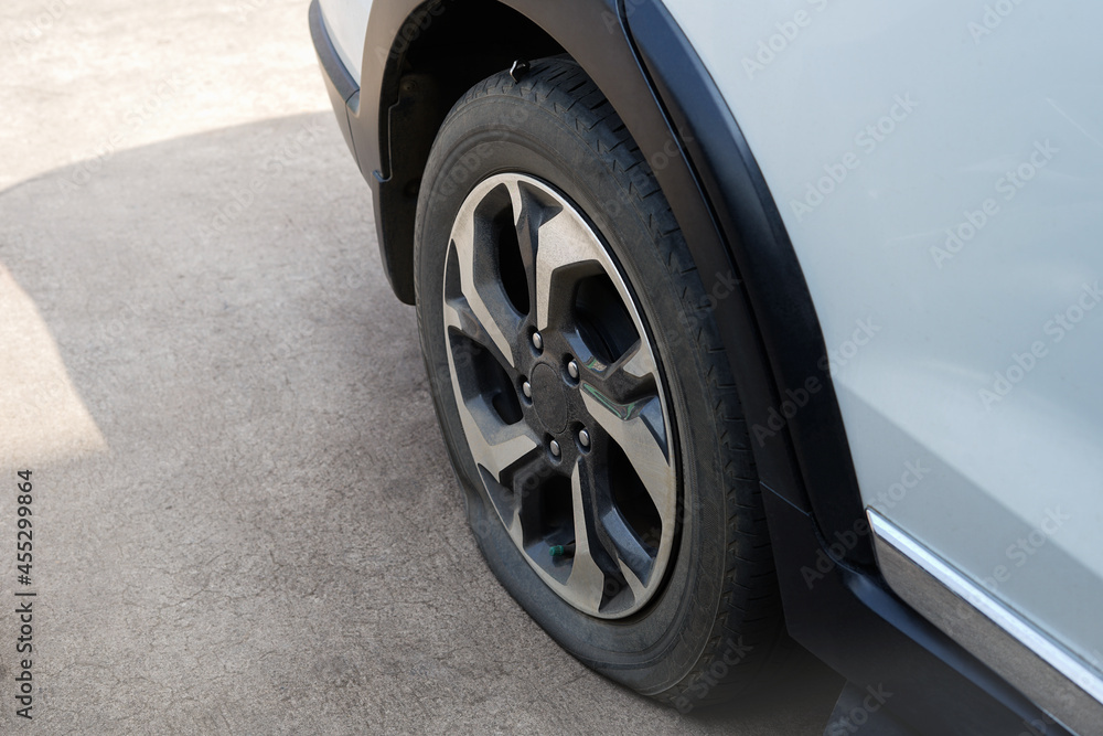 flat car tire parked on the street flat car tire parked on the street