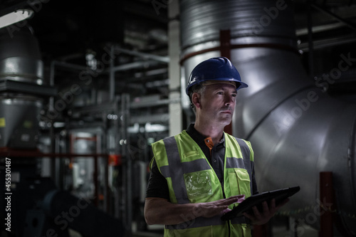 Male engineer inspecting an industrial plant room