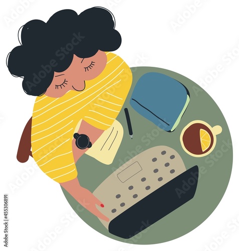 a woman working on a laptop remotely with a cup of tea with lemon