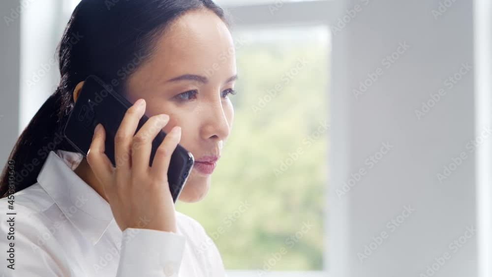 Asian business woman working at her table in a modern office. The workplace of a successful specialist. Business and finance concept. Asian business woman working at her table in a modern office. The workplace of a successful specialist. Business and finance concept.