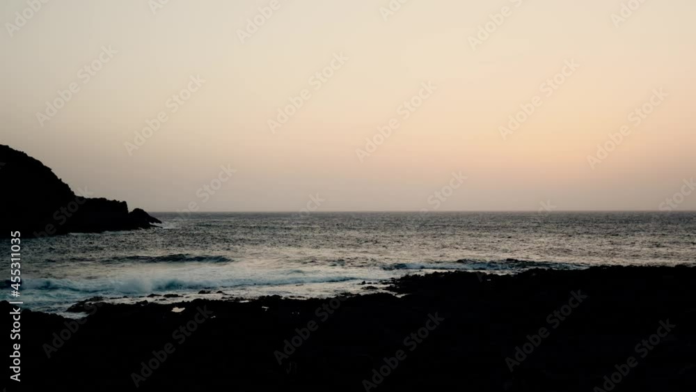 Time-lapse clip of magnificent ocean dark beach and cinematic sea. Magical calm bright sunset on wild coast. Scenery. Time-lapse clip of magnificent ocean dark beach and cinematic sea. Magical calm bright sunset on wild coast. Scenery.