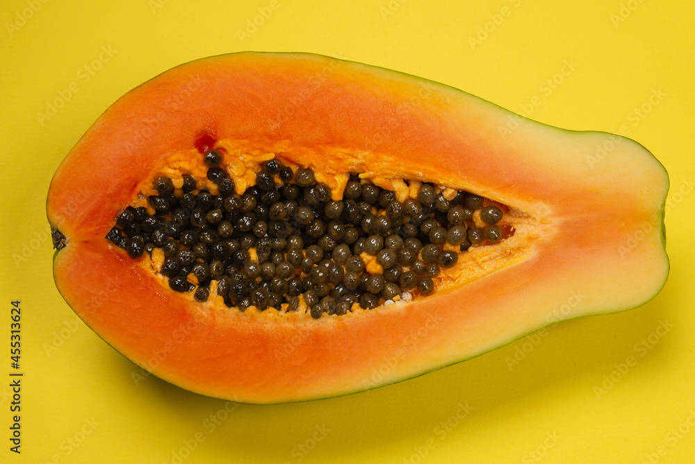 Papaya fruit on a yellow background. Tropical fruit. Papaya fruit on a yellow background. Tropical fruit.