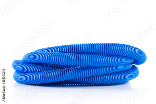 Roll of corrugated pipe tube for electrical installation isolated on white background