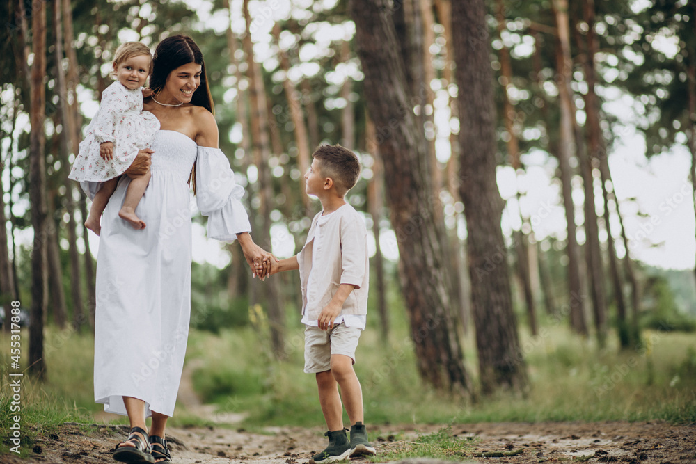 Fototapeta premium Mother with two kids in park
