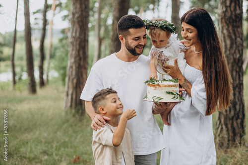 Family with baby girl and little son celebrating birhtday party photo