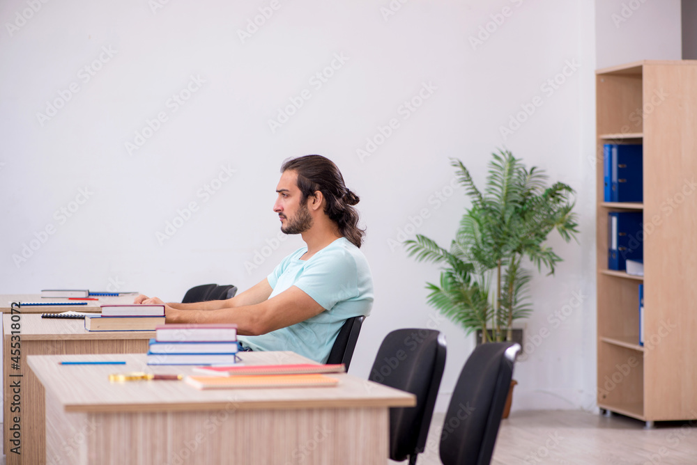 Young male student in the classroom during pandemic Young male student in the classroom during pandemic